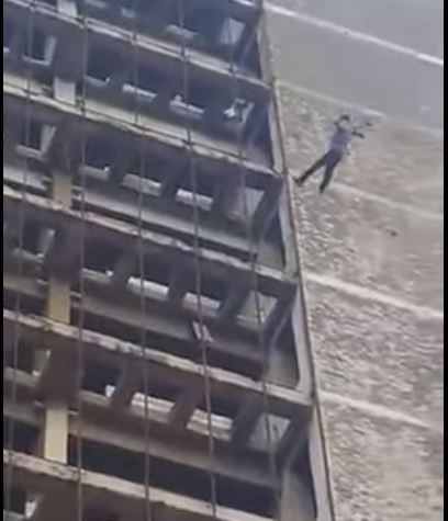 person falling off building
