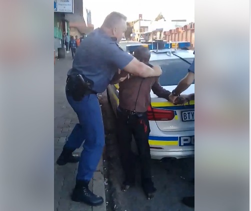 South African Police Officers Choke Nigerian Man On The Streets (Photos)