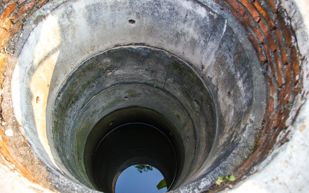 man trapped in well