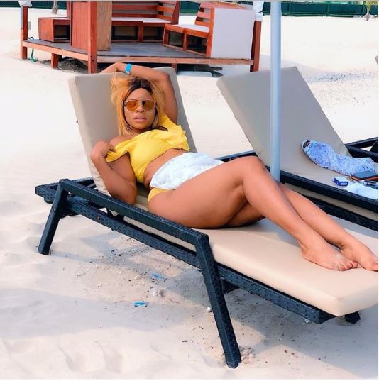 Laura Ikeji Stuns In Bikini As She Sits On Her Husband 