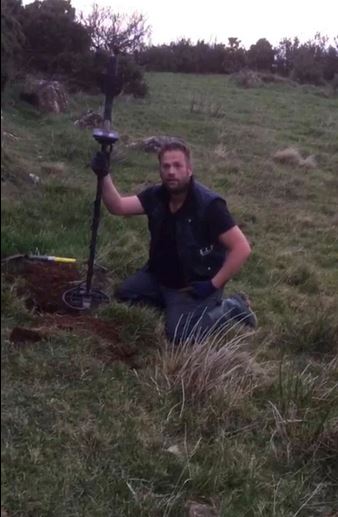 metal detectorist finds coins