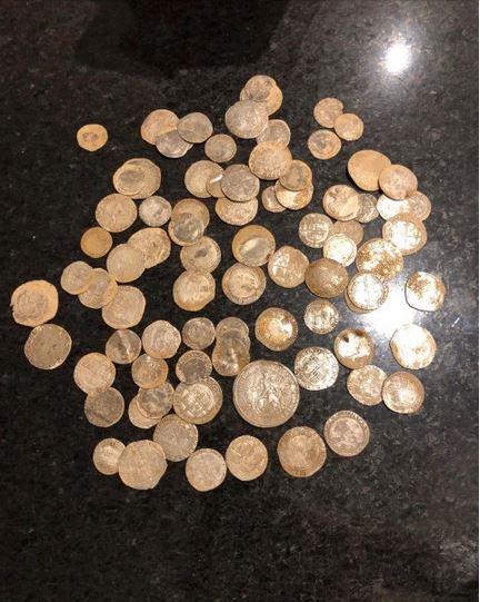 metal detectorist finds coins