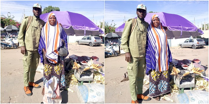 The NYSC member and the corn seller pose for a photo