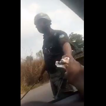 Police officer collecting bribe