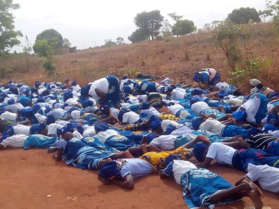 Women on the floor praying against coronavirus