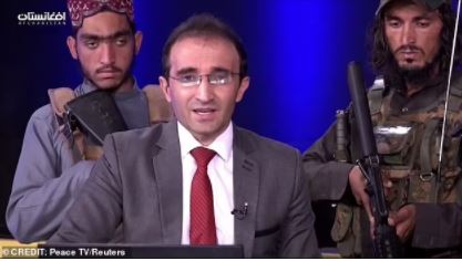 Presenter surrounded by Taliban militants