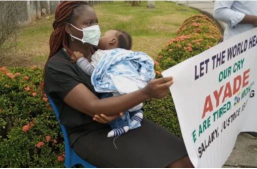 Female magistrate protesting with her baby after months of unpaid salaries