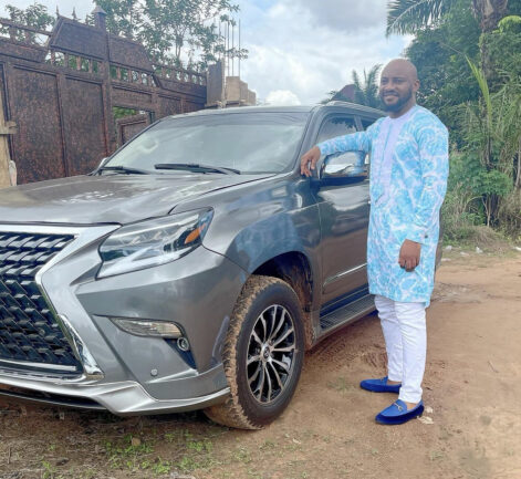 Yul Edochie posing with his brand new car